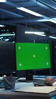 Vertical Engineer working with chroma key PC in data center used for managing gear energy consumption. Employee using isolated screen monitor in workspace used for automation in server farm, camera B video