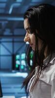 Vertical IT specialist in data center providing technical support to customers, troubleshooting issues. Server farm worker carrying out operational technical interventions requested by clients, camera B video