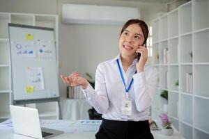 Young Accountant Using Telephone While Working on Paperwork in Modern Office Setting photo