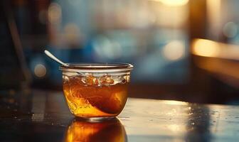 Apple jam in a clear jar with a small spoon inside photo