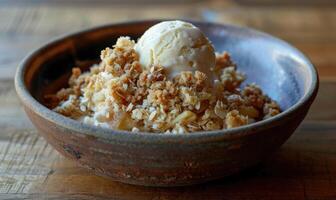 Apple crumble with a scoop of vanilla ice cream in a rustic bowl photo