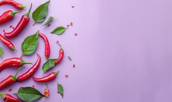 Top view of hot peppers scattered on a purple background photo