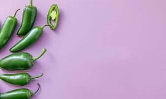 Top view of a jalapeno peppers arranged on a pastel purple background photo