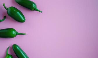 Top view of a jalapeno peppers arranged on a pastel purple background photo