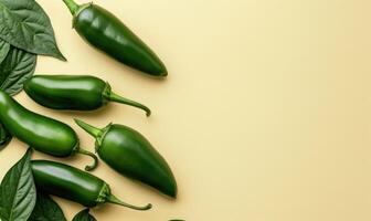 Top view of a jalapeno peppers arranged on a light yellow background photo