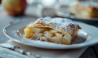 Apple strudel with powdered sugar on top photo