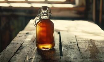 Bottle of apple syrup on a rustic wooden table photo