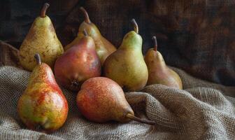 Different varieties of pears on a burlap cloth photo