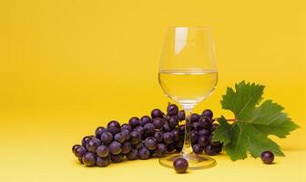 Grapes on a warm yellow background with a glass of white wine photo