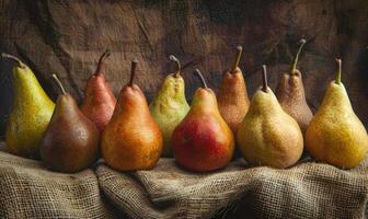 Different varieties of pears on a burlap cloth photo
