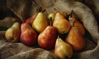 Different varieties of pears on a burlap cloth photo
