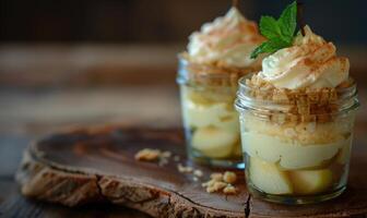 Pear and mascarpone layered dessert in a jar, topped with a sprig of mint photo
