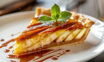 Slice of apple tart topped with caramel sauce photo