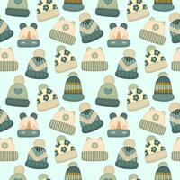 Seamless pattern or background with warm different hats in blue colors on autumn or winter theme on light background. vector