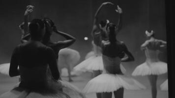 Ballerinas in white tutus, view from backstage. Black and white photos