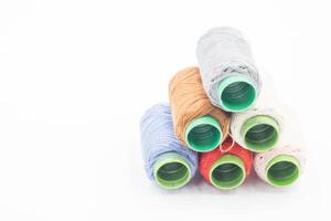 Colorful Spool of sewing thread, spool of industrial threads, Colored spools of thread on a white background. photo