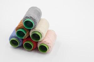 Colorful Spool of sewing thread, spool of industrial threads, Colored spools of thread on a white background. photo