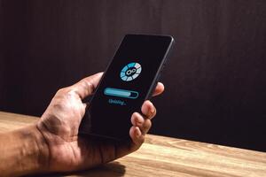 The process of updating the software system or applications on a smartphone photo
