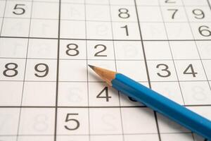 Sudoku puzzle game playing to challenge brain. photo