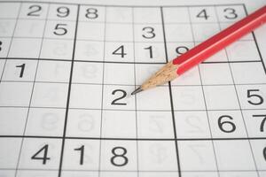 Sudoku puzzle game playing to challenge brain. photo