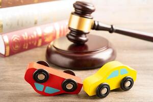 Hammer gavel judge with car vehicle accident, insurance coverage claim lawsuit court case. photo