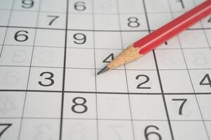 Sudoku puzzle game playing to challenge brain. photo