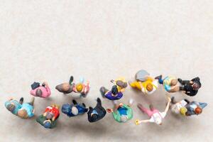 Top-down view of a group of miniature people showing different clothing and poses. photo