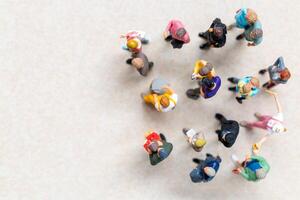 Top-down view of a group of miniature people showing different clothing and poses. photo