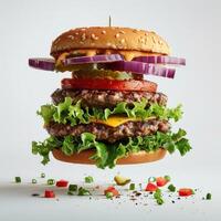 a close up of a hamburger with lettuce, tomato, onion, and pickles photo