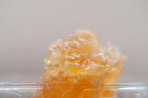 Wild honey, natural organic food, in a glass bottle photo