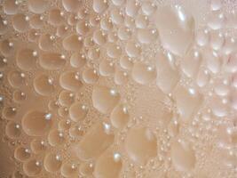 Drops of ice on an iced coffee glass photo