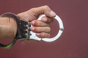 Police demonstrate the use of handcuffs photo
