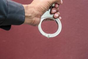 Police demonstrate the use of handcuffs photo