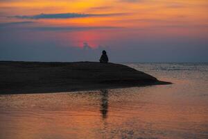 Women walk and lounge at beach in the evening. photo