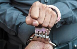 Police demonstrate the use of handcuffs photo
