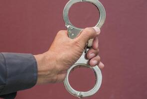 Police demonstrate the use of handcuffs photo