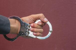 Police demonstrate the use of handcuffs photo