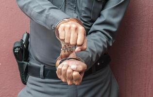 Police demonstrate the use of handcuffs photo