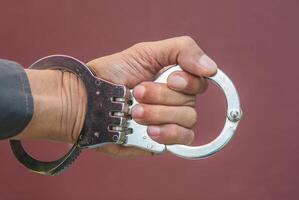 Police demonstrate the use of handcuffs photo