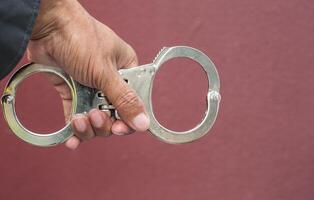 Police demonstrate the use of handcuffs photo