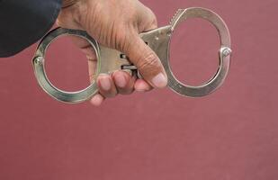 Police demonstrate the use of handcuffs photo