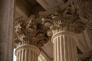 Ornate Classical Columns of Antique Design with detailed Corinthian Capitals Decorated with intricate Leaf pattern. Architectural elements Historic building characterized exquisite craftsmanship photo