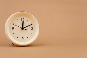 Alarm clock photography in a light brown background studio The concept of time and living and working photo
