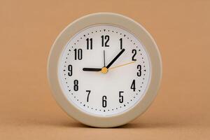 Alarm clock photography in a light brown background studio The concept of time and living and working photo