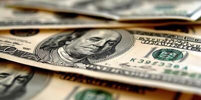 A close-up view of a US one hundred dollar bill, with Benjamin Franklin's portrait in focus photo