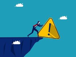 businessman pushing a cliff with a caution sign vector