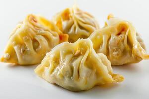 Four Steamed Dumplings on a White Plate photo