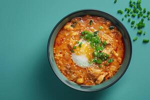 Spicy Korean Noodle Soup with Egg and Sesame Seeds photo