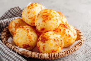 Golden-Brown Cheese Bread Rolls in a Wicker Basket photo