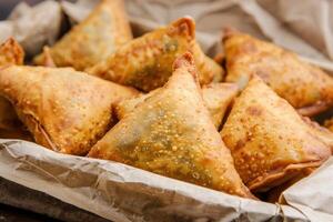 A Close-Up View of Deep-Fried Samosas in a Paper Bag photo